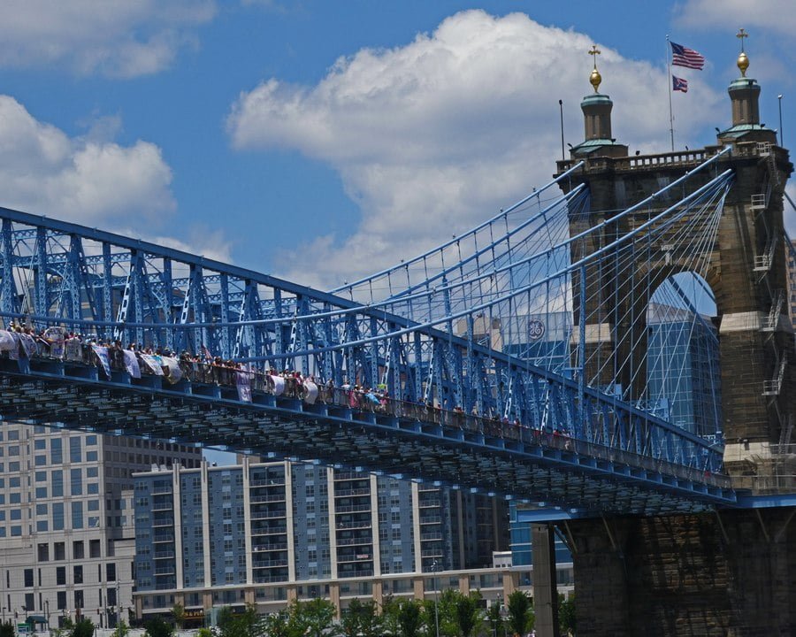 Photo taken from west side of bridge, with demonstrators marching on bridge.