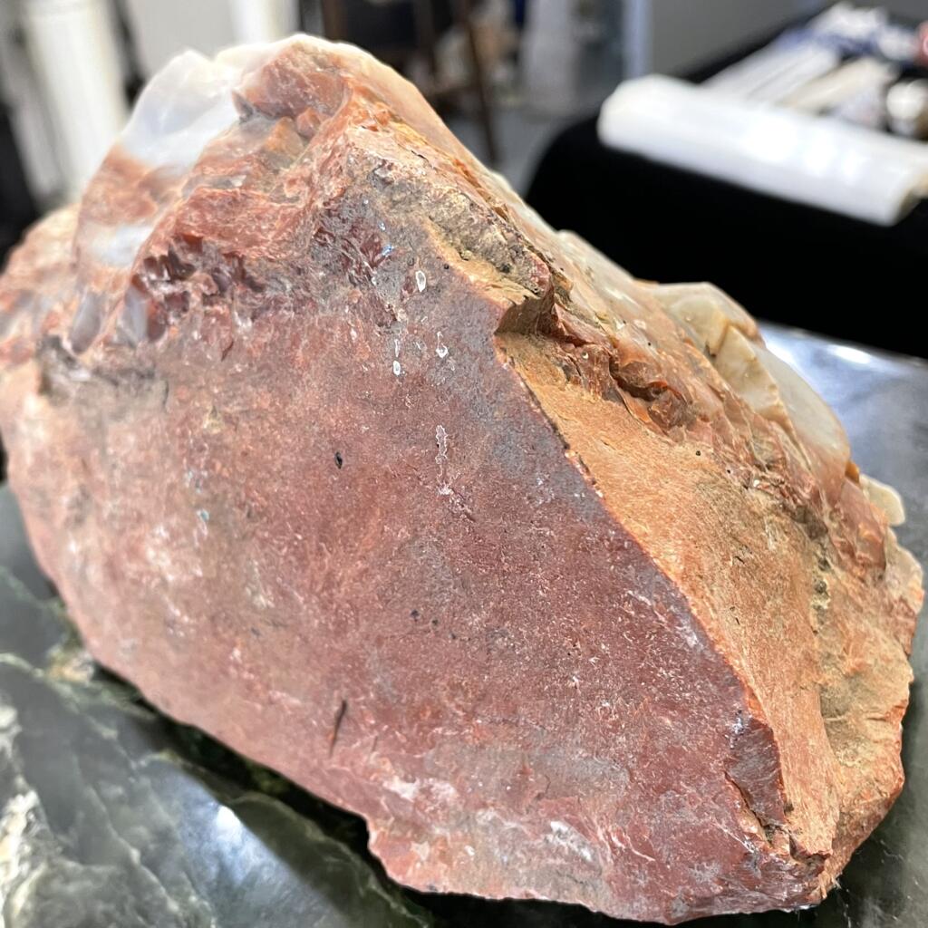 Arizona Rainbow Petrified Wood, weighing 4lbs 10oz (2111g), with blue-grey on rust hues and rough, uneven surfaces, sits atop a dark tabletop.