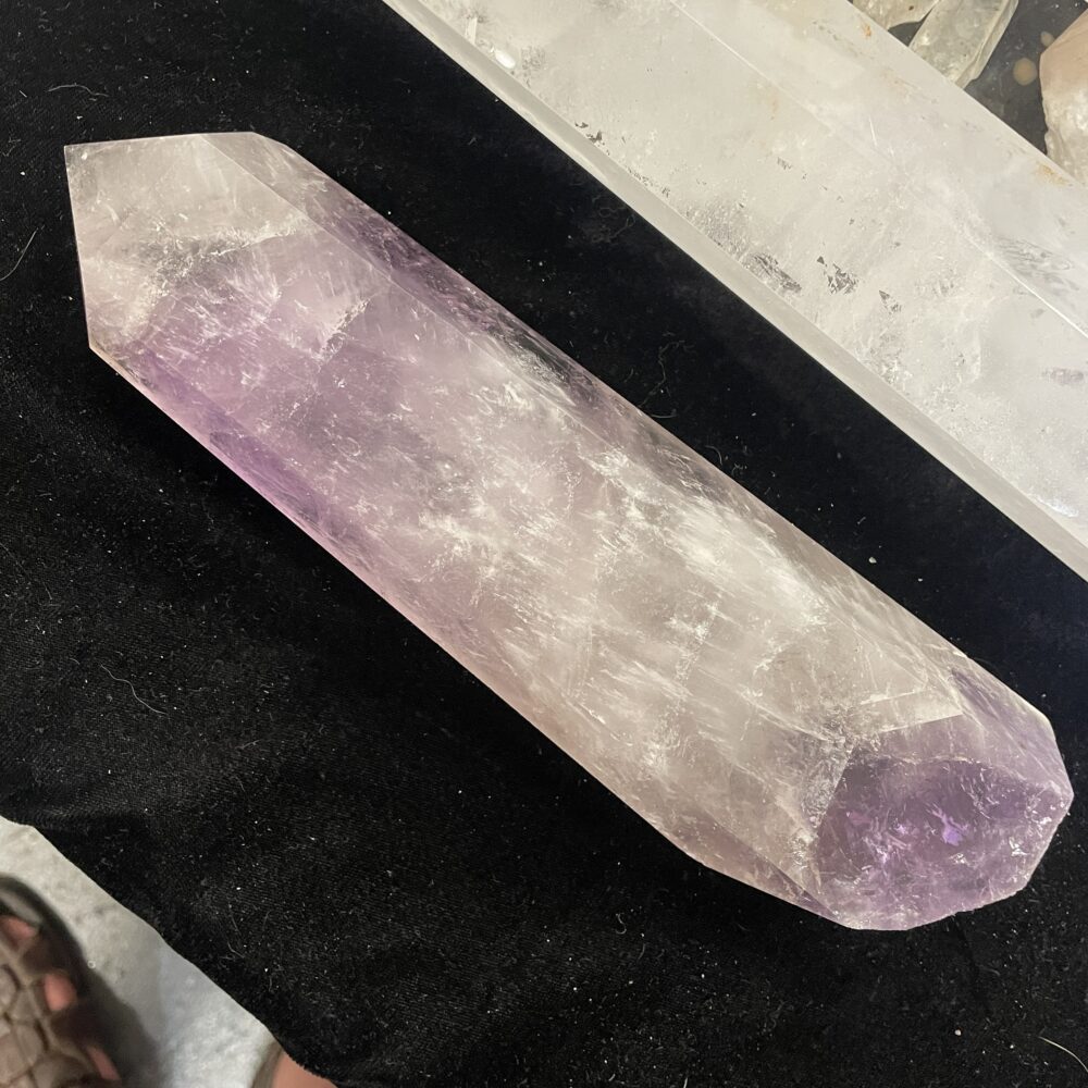 The Rare 15.4 Inches Smoky Quartz Crystal (5 lbs 10 oz) rests on a black surface, displaying a faint purple hue and double-terminated form.