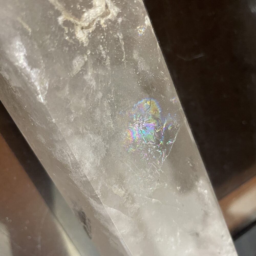 Close-up of the Rare 19.8 Long Milky and Clear Quartz Crystal (6 lbs 12 oz) reveals a visible internal fracture with rainbow-like iridescence, showcasing the stunning clarity often found in high-quality quartz.