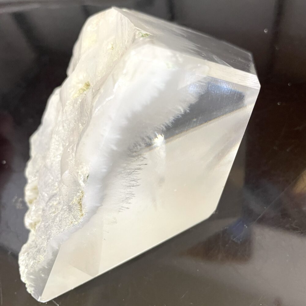 A rare Okenite inside Optical Calcite (Icelandic Spar) from India, 1 lb 4.9 oz (593g), shown on a reflective dark surface.