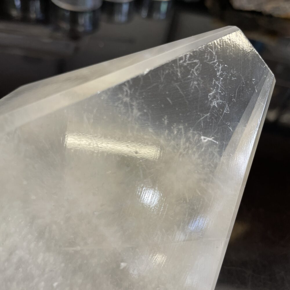 Close-up of rare Okenite inside optical calcite (Icelandic Spar) from India, 1 lb 4.9 oz (593g), on a dark reflective background.